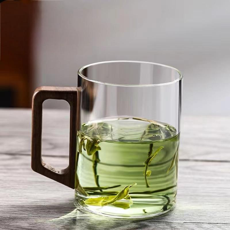 High end green tea cup with walnut handle and lid. High temperature resistant glass